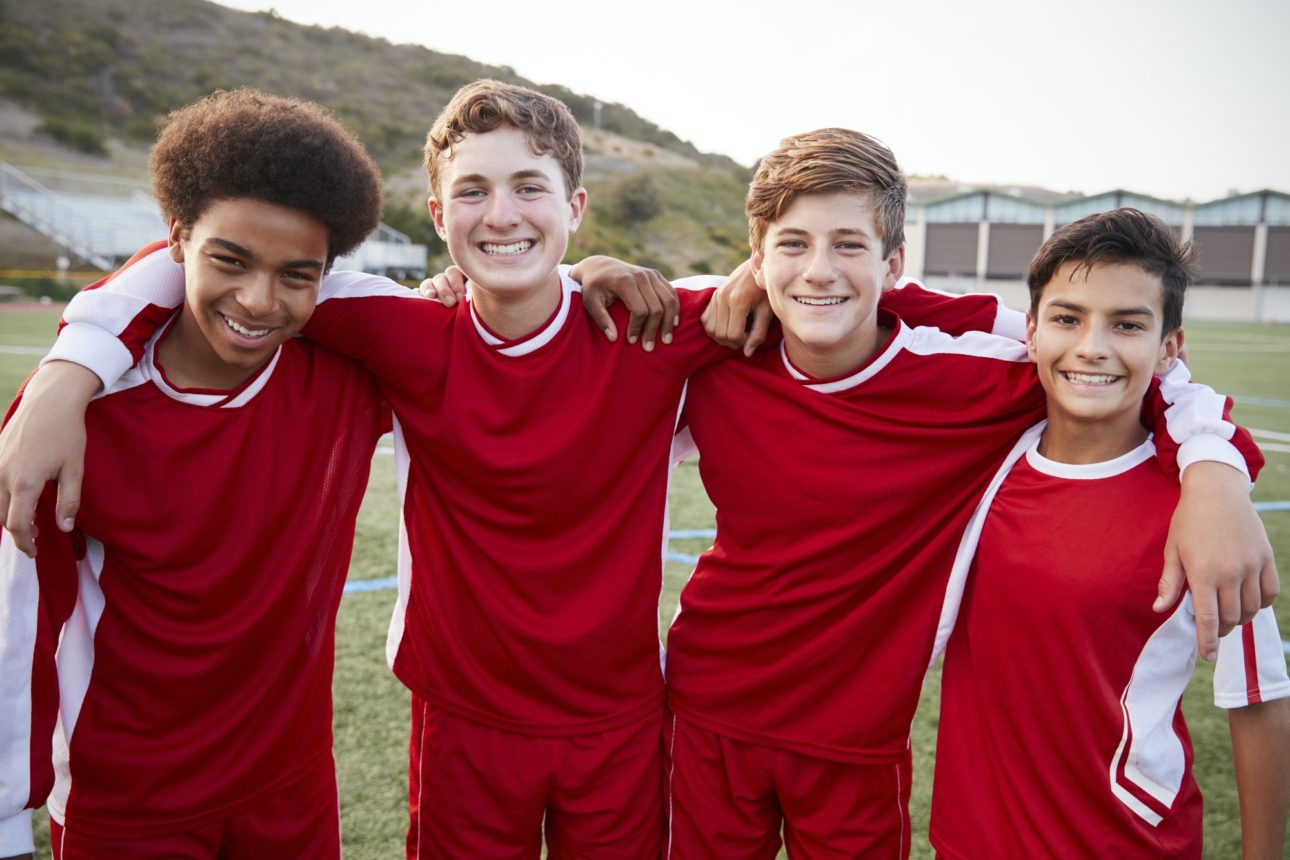 Portrait Of Male High School Students Playing In Soccer Team