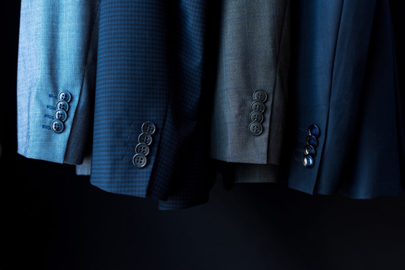 close-up view of fashionable suit jackets in boutique