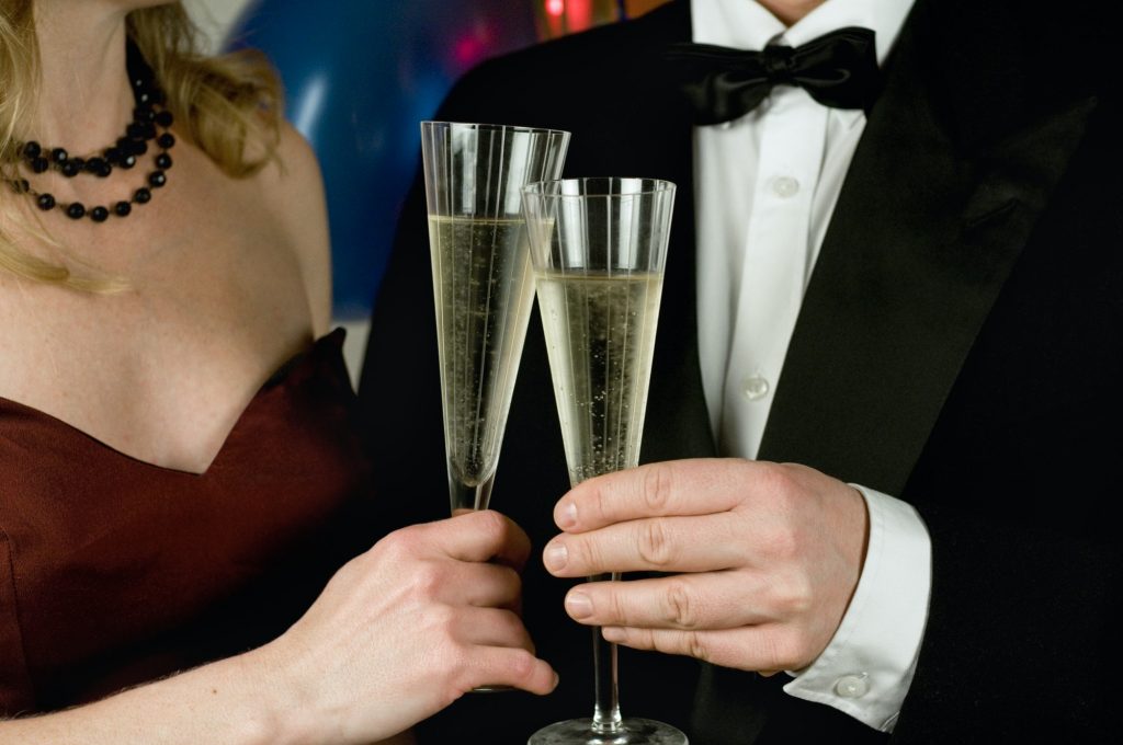 Elegant couple holding champagne glasses