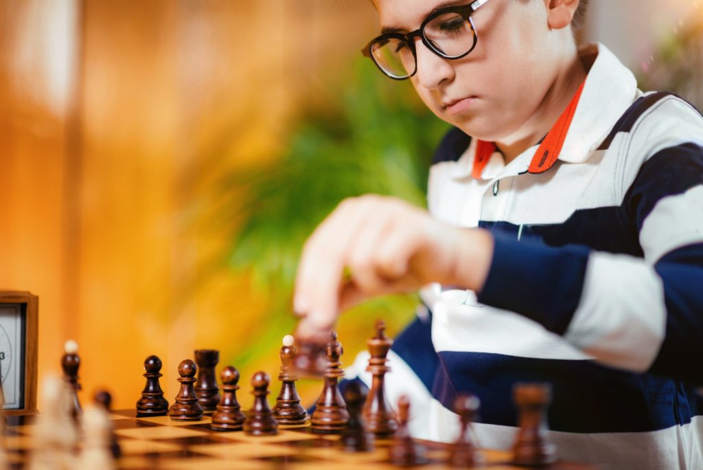 School boy playing chess
