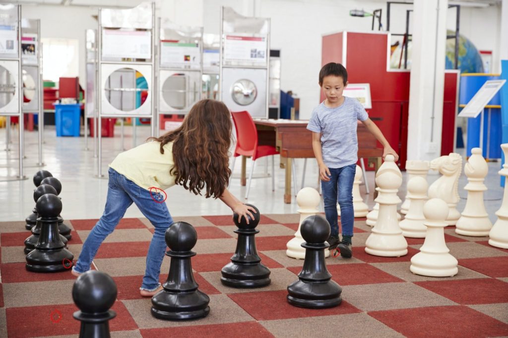 Schoolchildren playing giant chess at a science centre