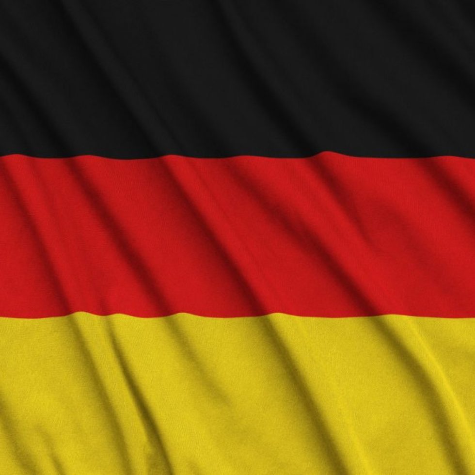 Germany flag is depicted on a sports cloth fabric with many folds. Sport team waving banner