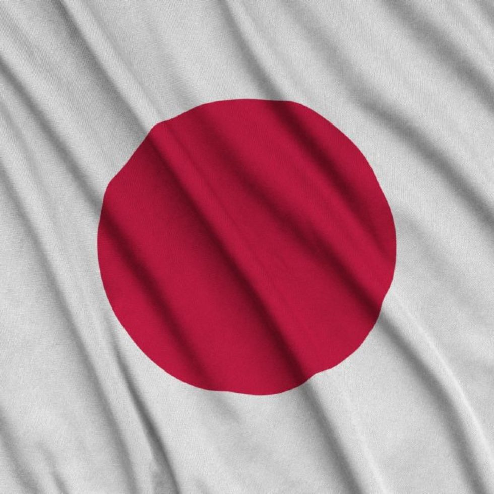 Japan flag is depicted on a sports cloth fabric with many folds. Sport team waving banner
