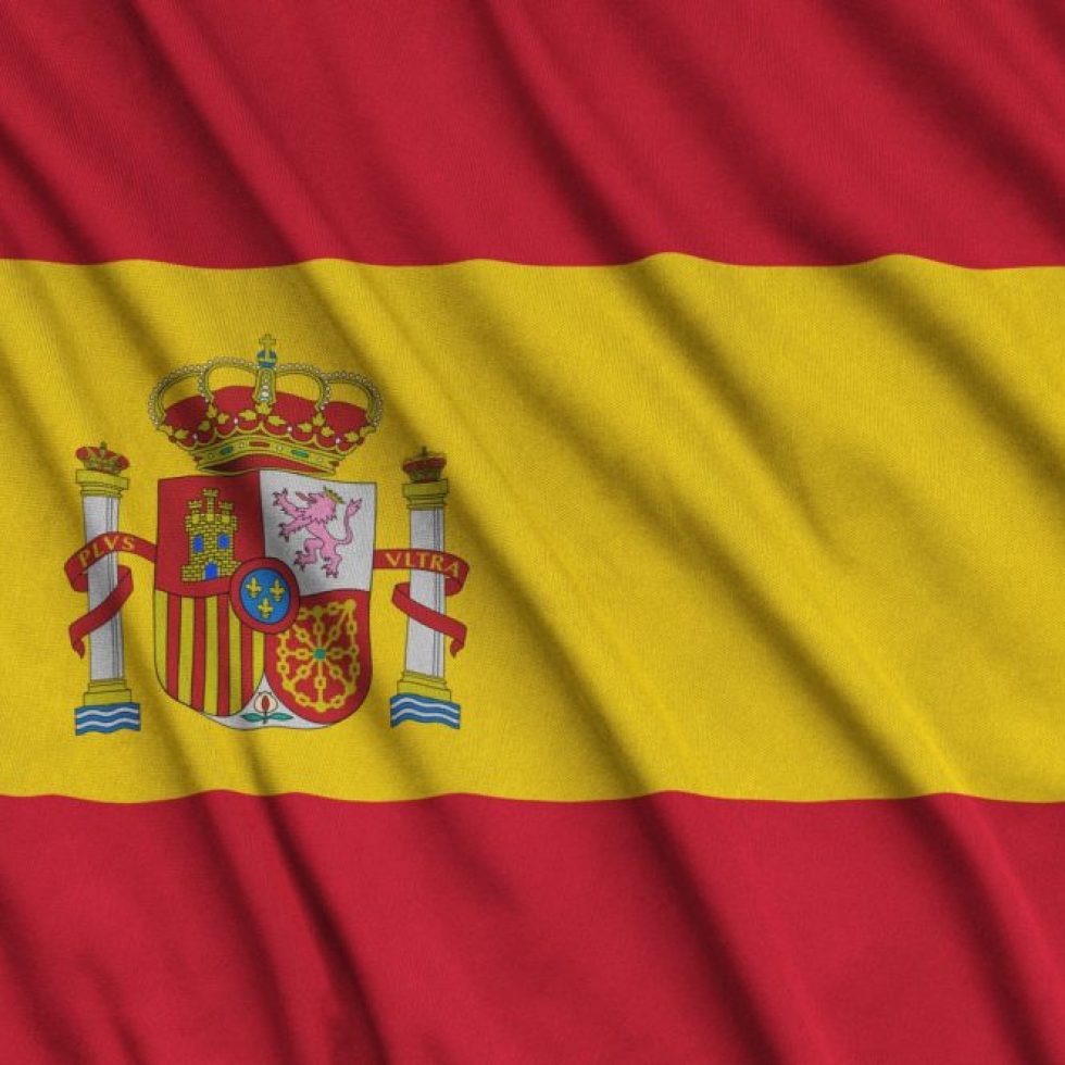 Spain flag is depicted on a sports cloth fabric with many folds. Sport team waving banner