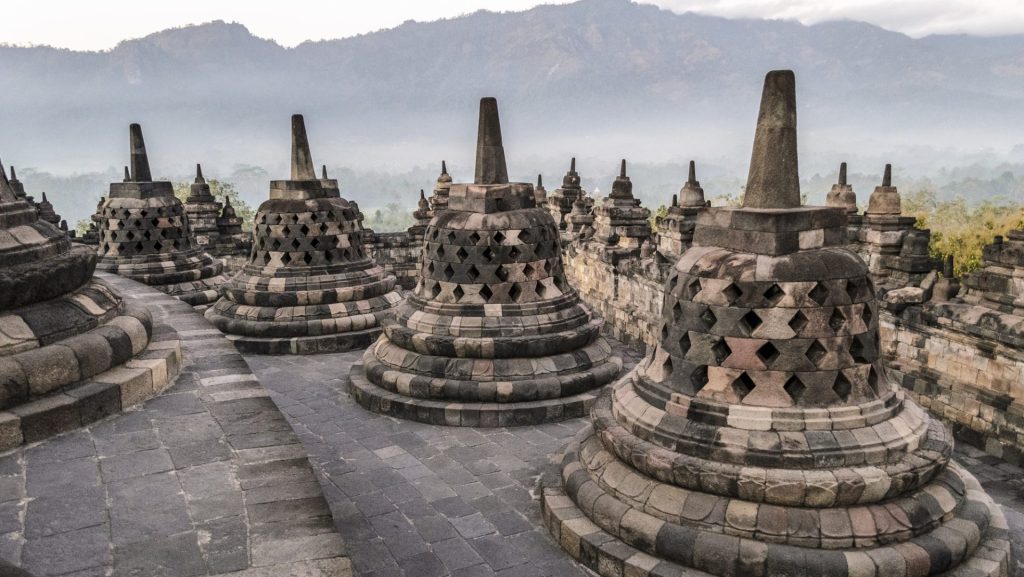 Borobudur temple, a 9th century Buddhist temple with terraces and stupa with latticed exterior, bell
