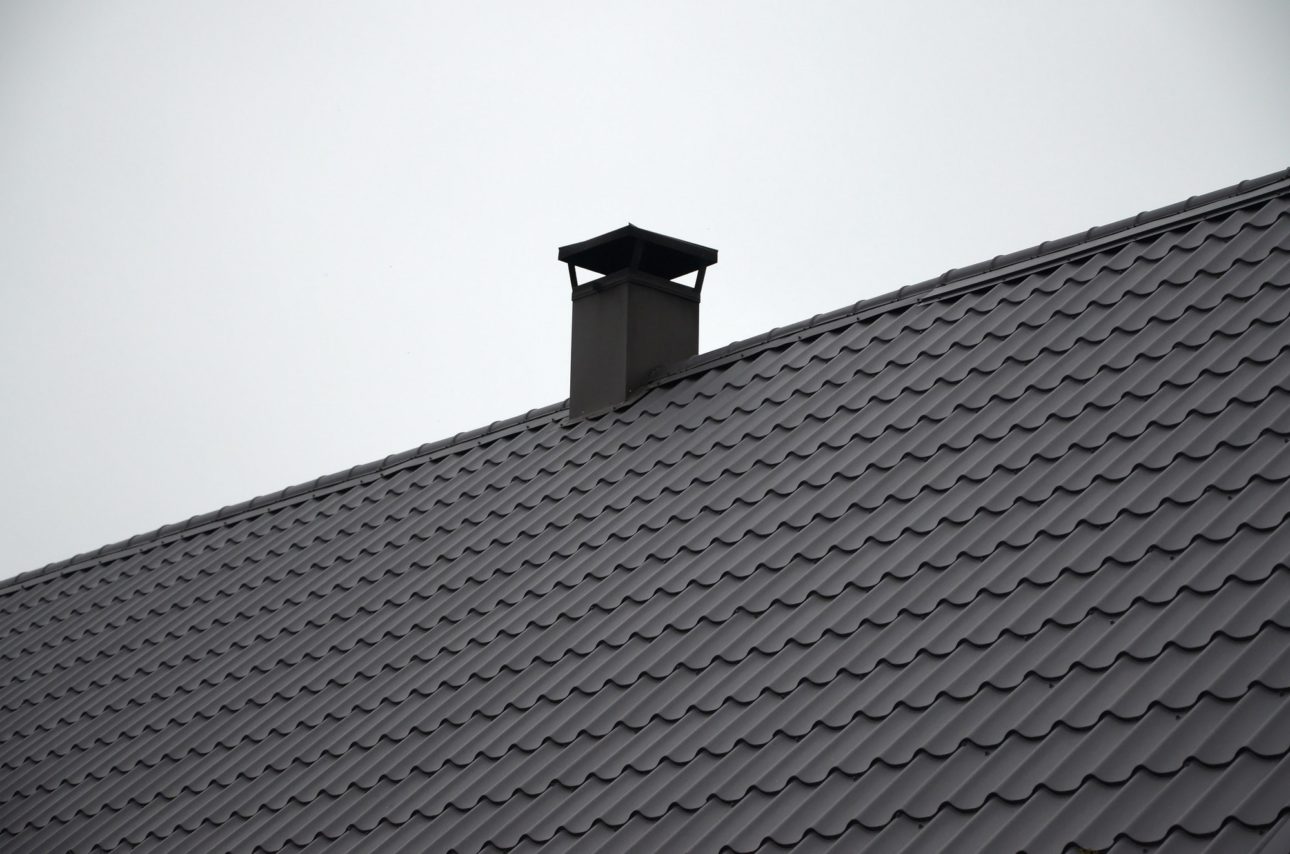 Modern brown roof made of metal. Corrugated metal roof and metal