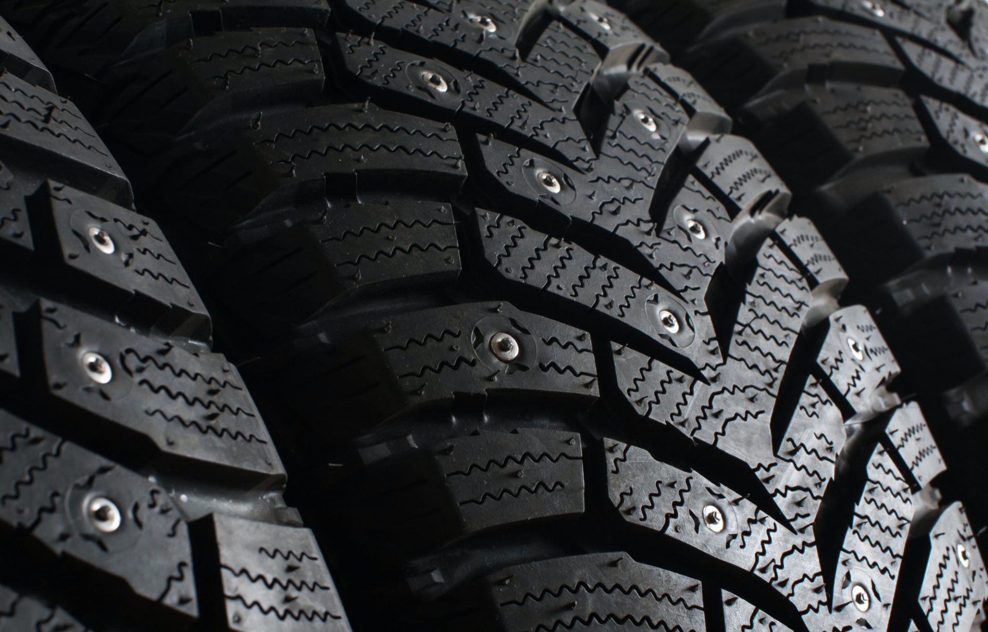Winter tires with spikes for a car close up