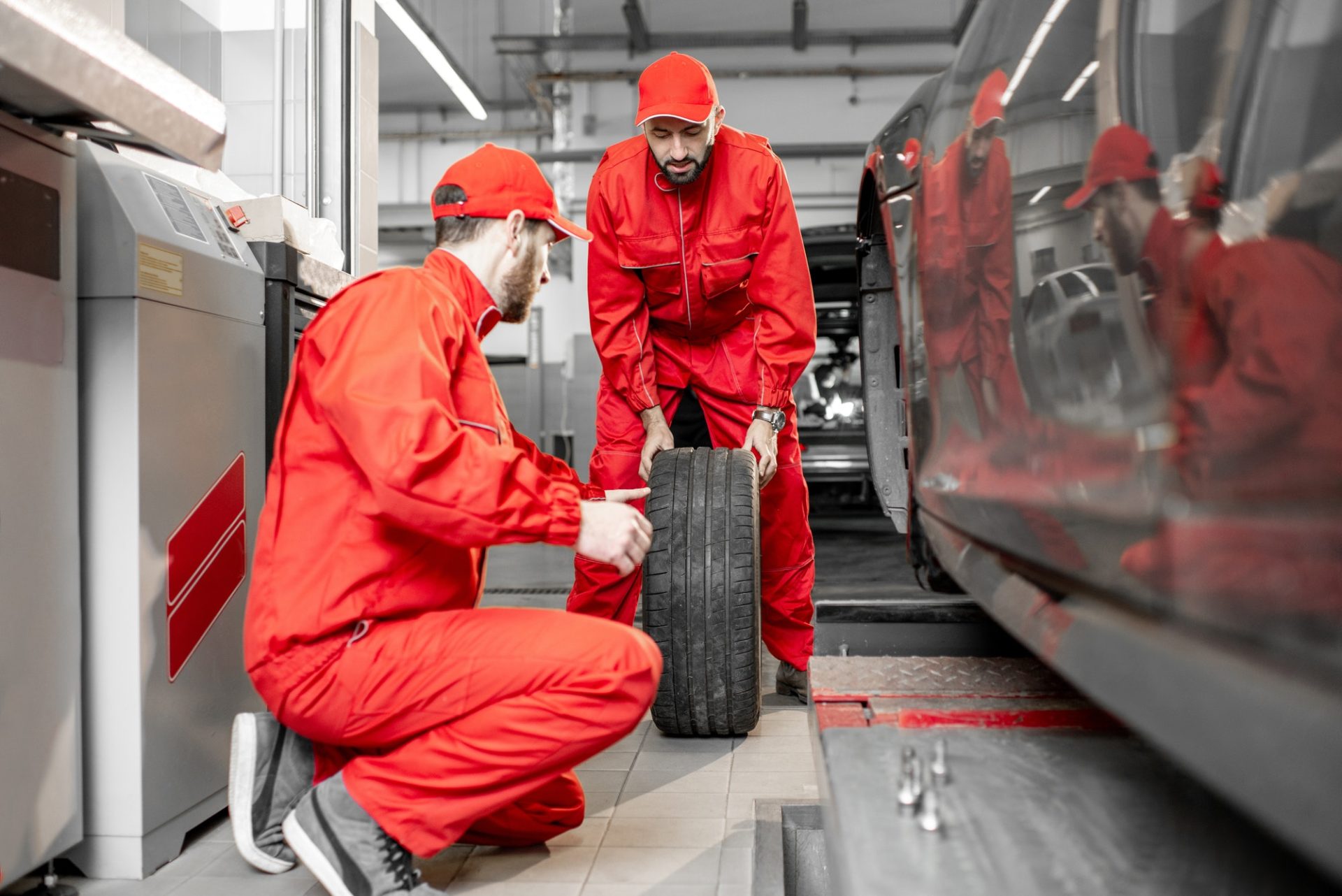 Workers changing wheels at the car service