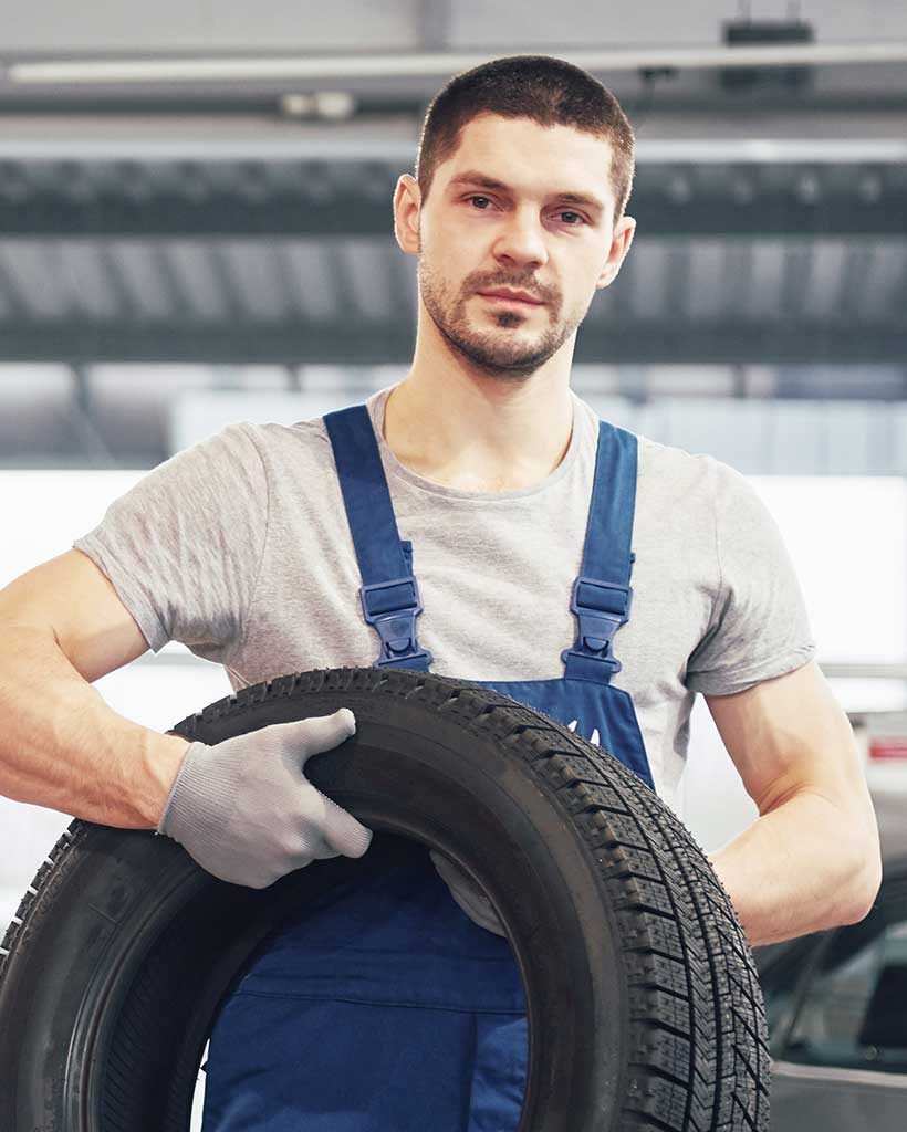 mechanic-holding-a-tire-tire-at-the-repair