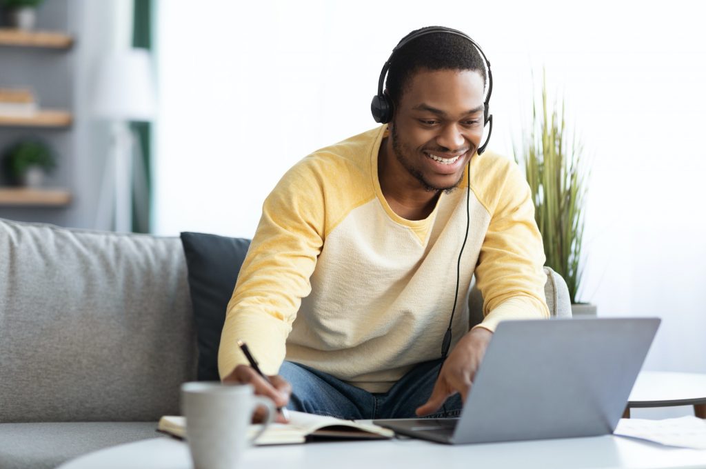 Positive black guy attending online training from home