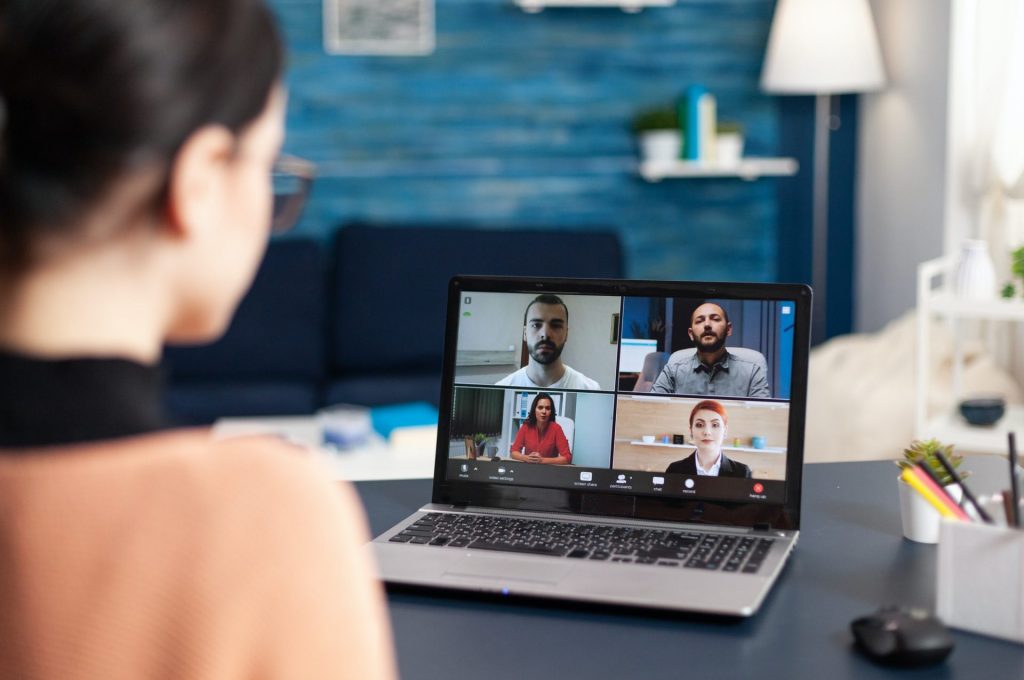 Student listening colleagues during online videocall school