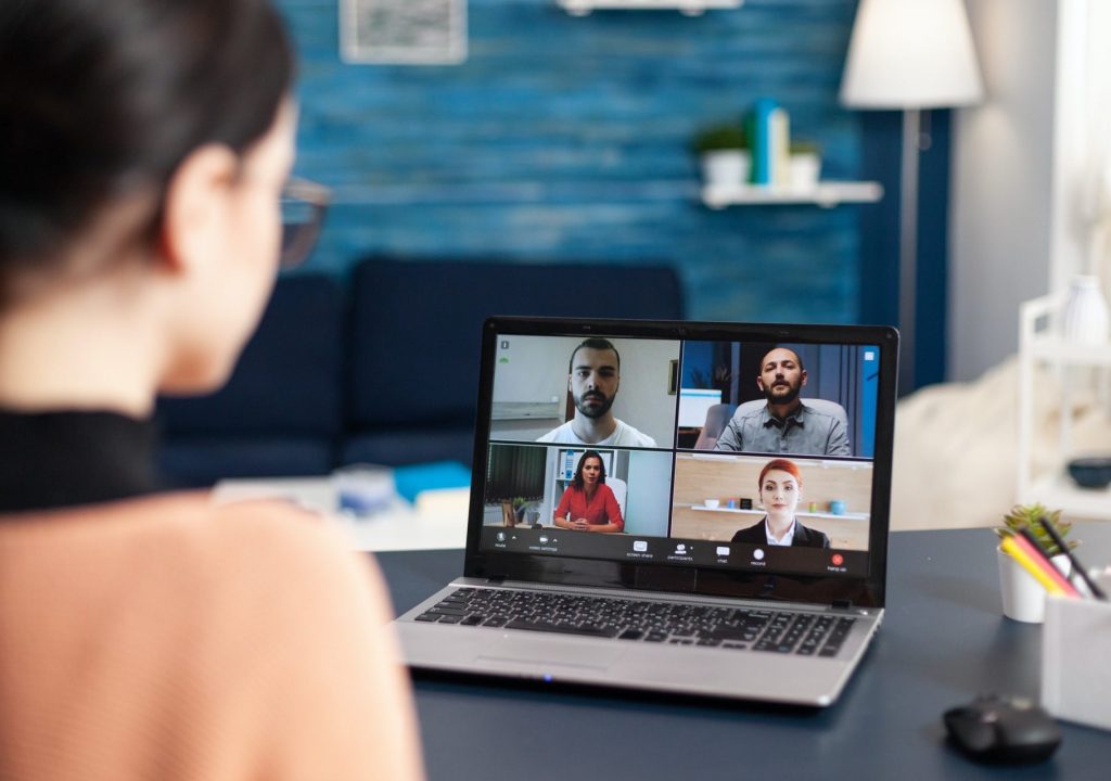 Student listening colleagues during online videocall school