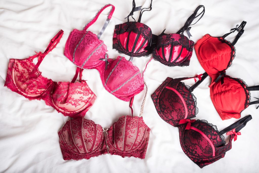Fashion: Lingerie. A colourful / colorful selection of red bras / lingerie on a white background. 5