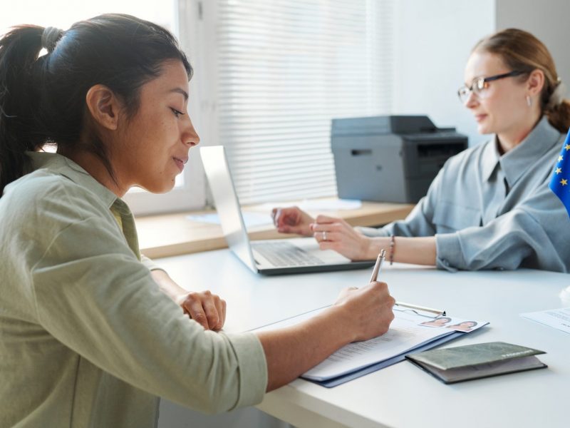 Woman Filling In Visa Application Form