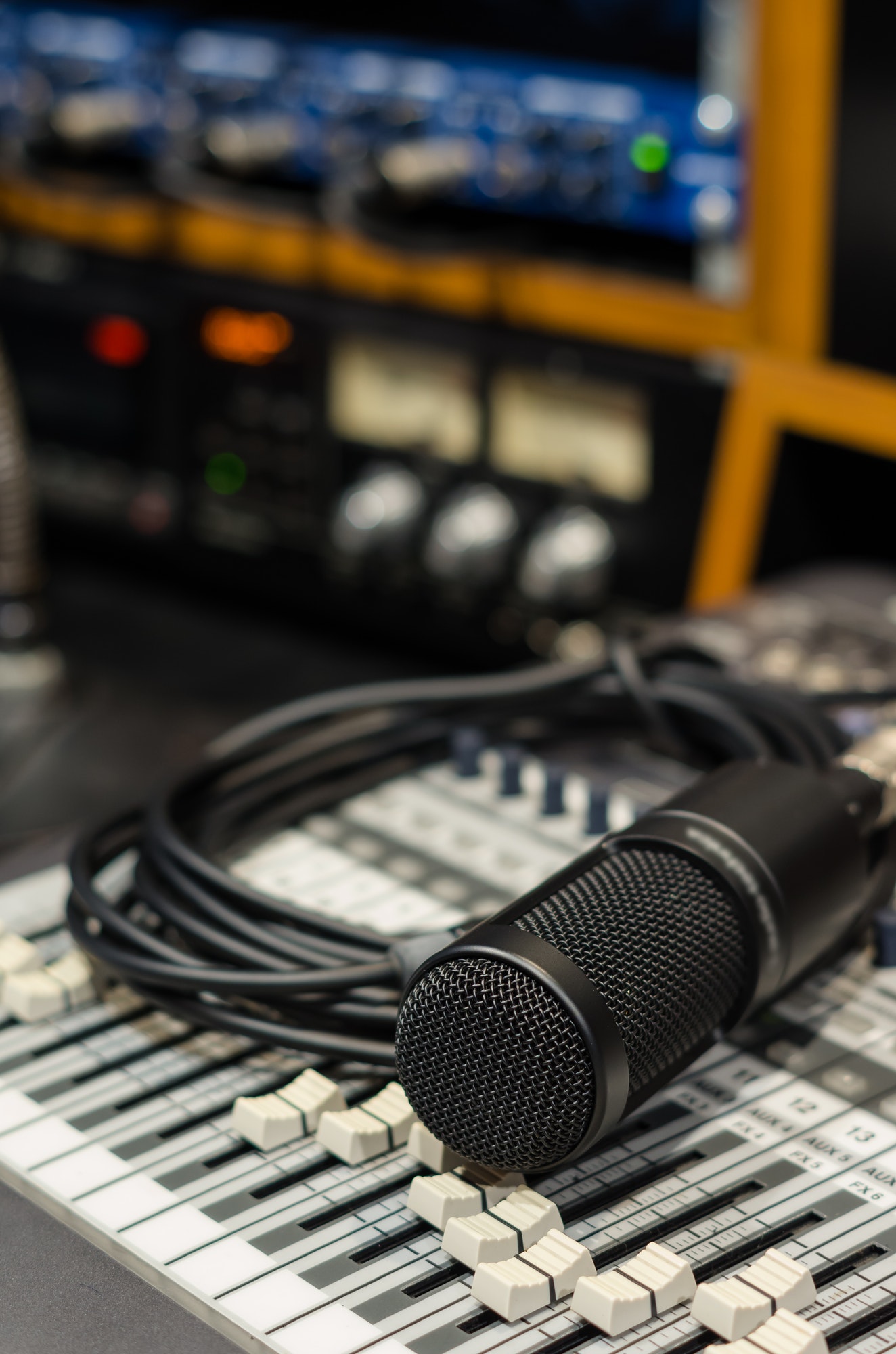 Close up of microphone with equipment on mixer in music studio, music instrument concept