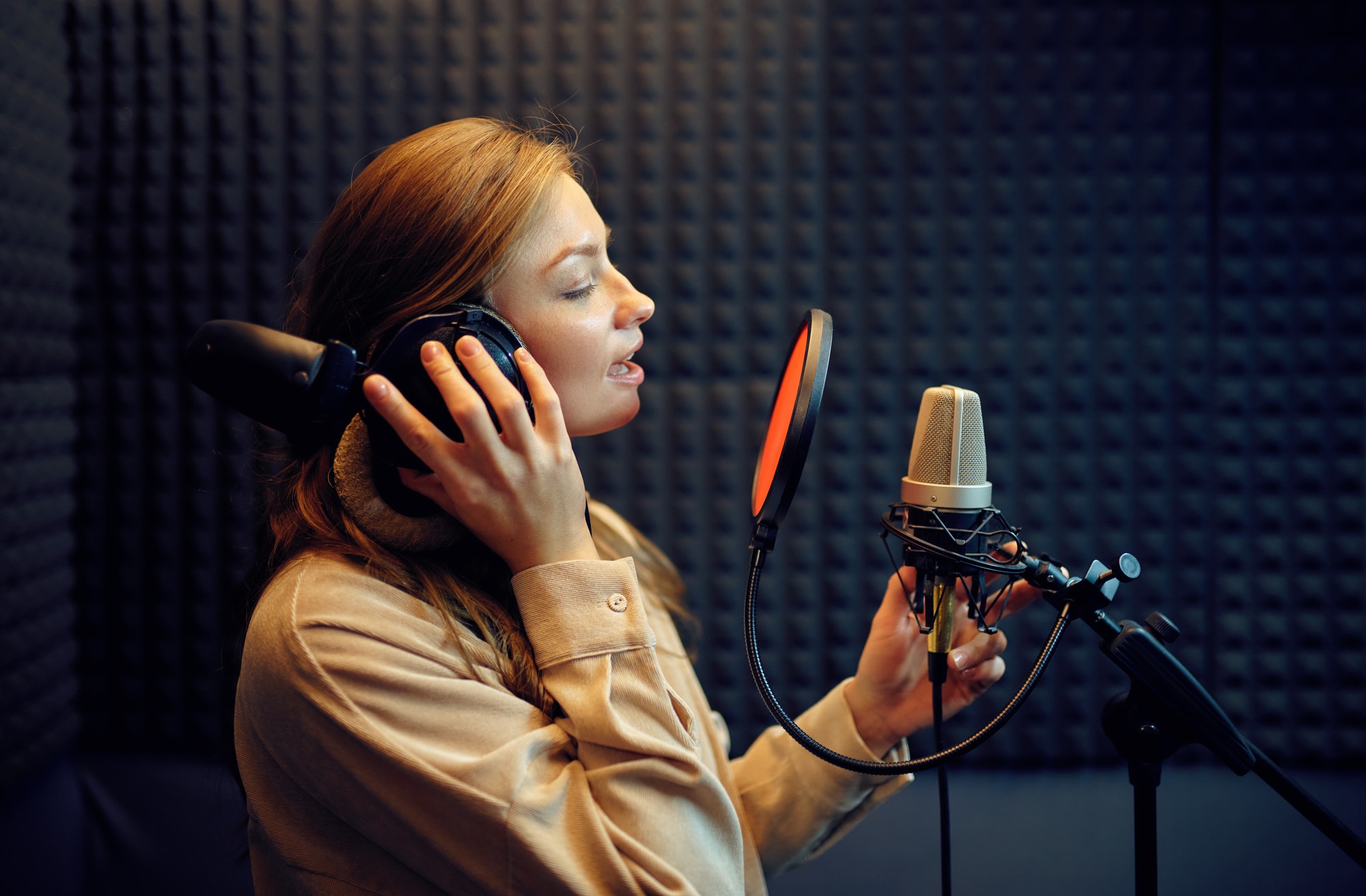 Female singer sings a song, recording studio