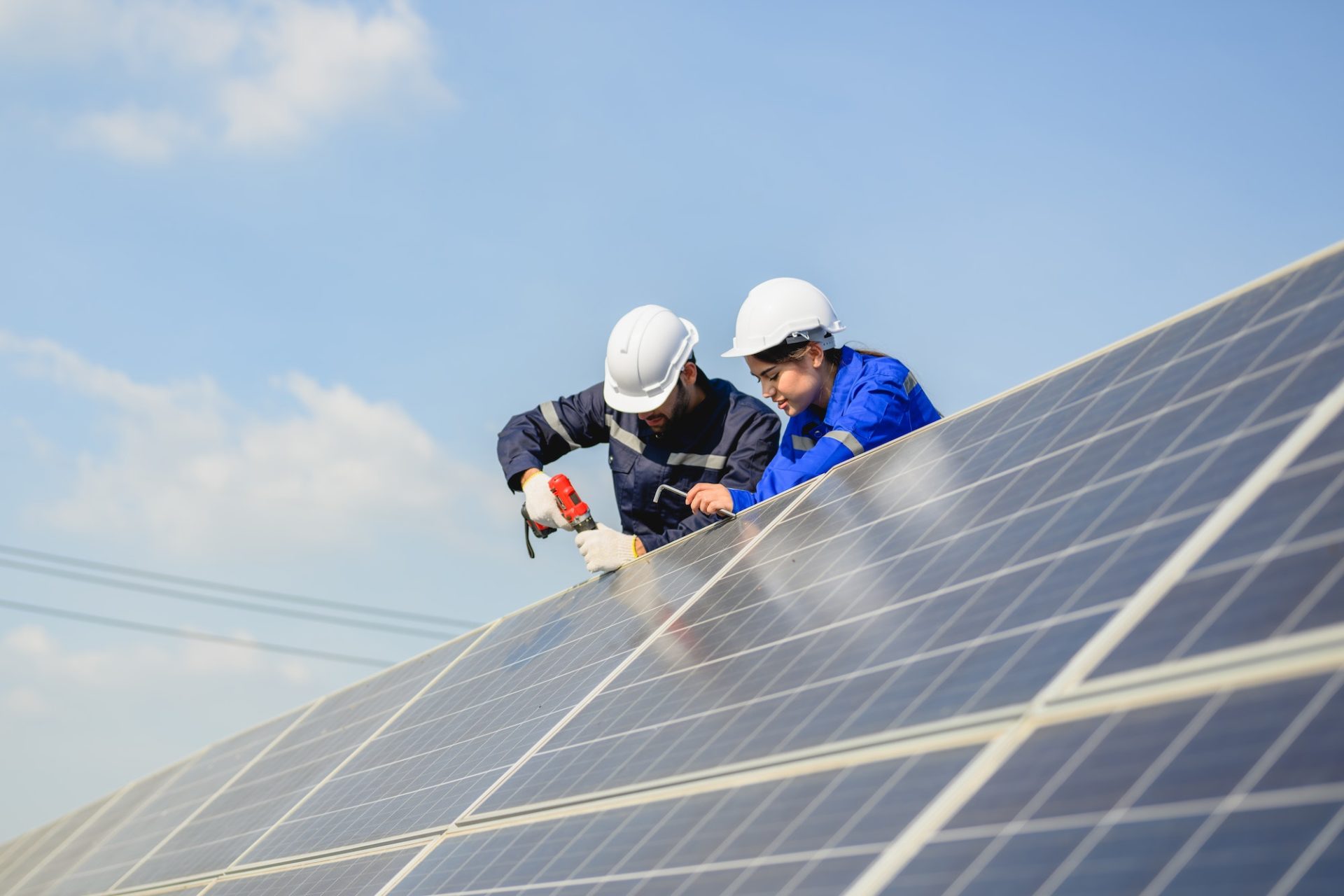 Technicians workers installing solar panels at solar cell farm