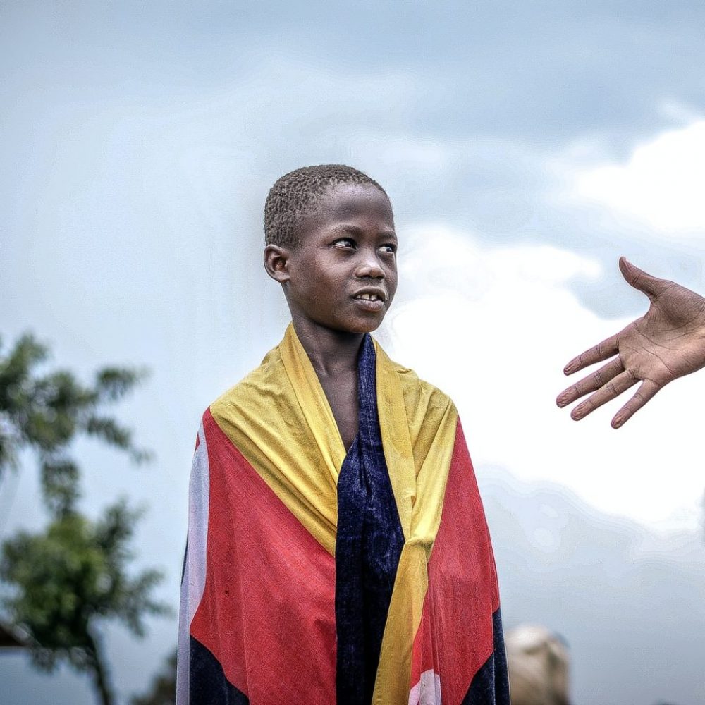 African Boy looking at a raised Hand