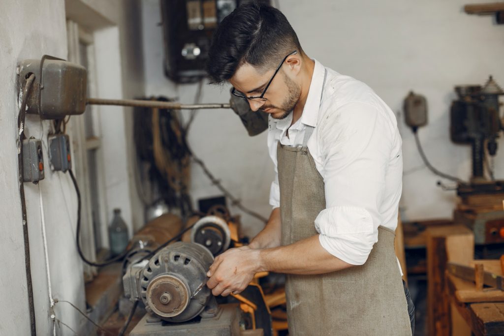 Handsome carpenter working with a wood