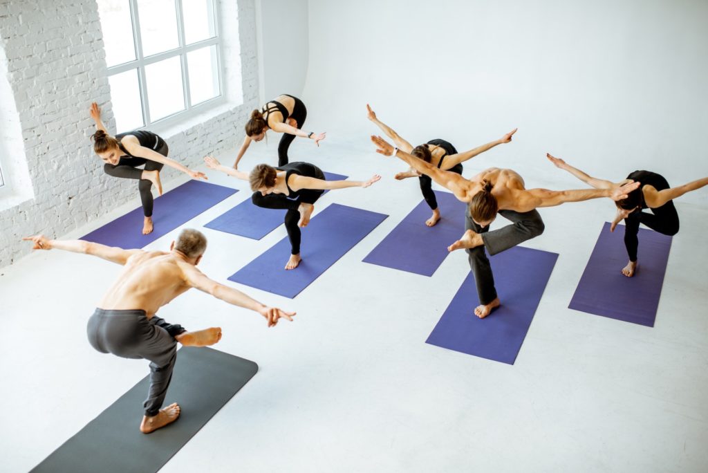 Group of people practising yoga indoors