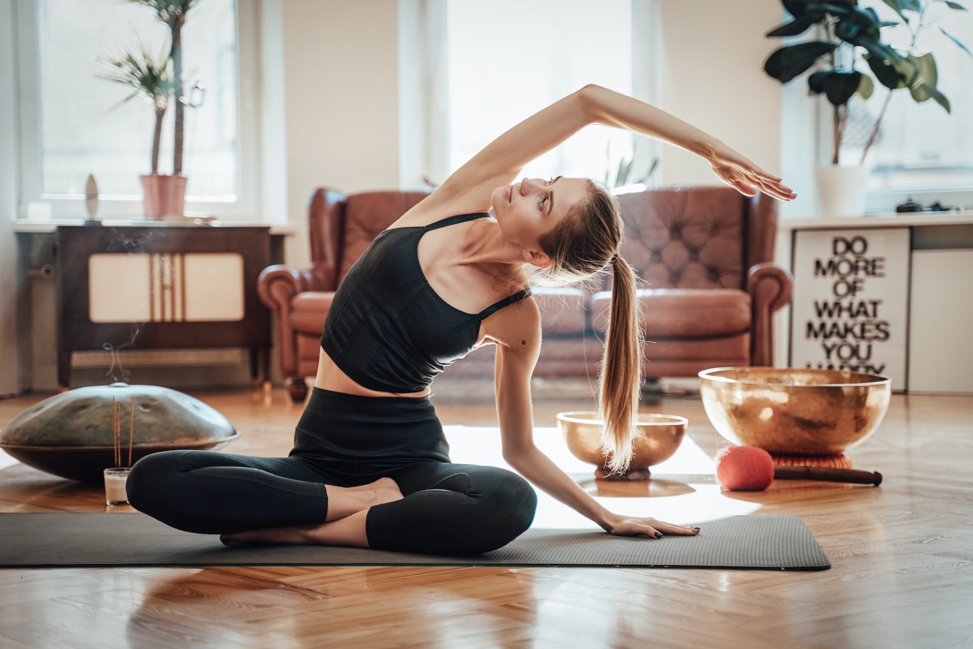 Relaxed caucasian woman doing yoga at home in daytime